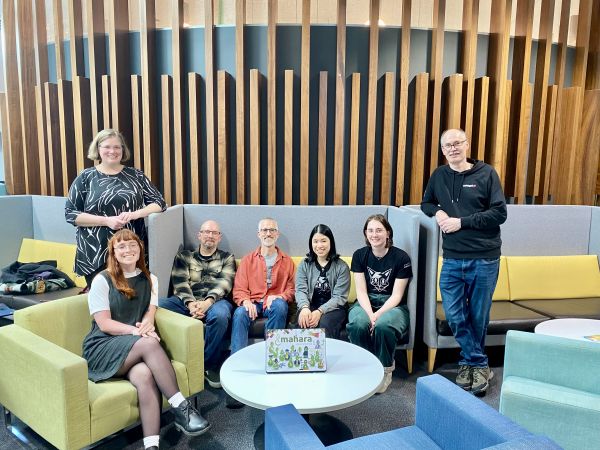 A group photo of the Mahara project team at Catalyst smiling includes Kristina Hoepnner, Mahara project lead, Robert Lyon, Mahara technical lead,, Phil Sanity, senior developer, Doris Tam, developer, Yvonne Waterman, junior developerjoined by marketing executive Courtney Brown, and BA analyst Rob Hill.