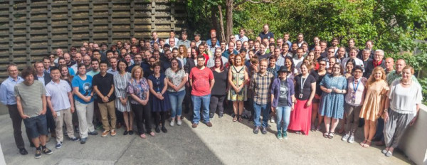 A large group of people from Catalyst standing outside