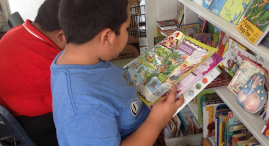 kids looking at books in a library