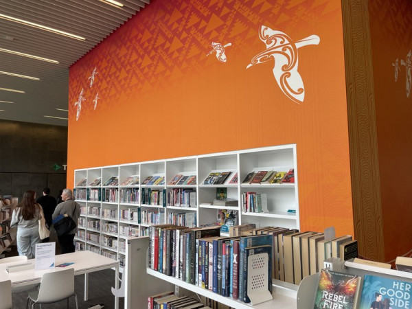 A wall of books and art on the Children’s floor at Tūranga