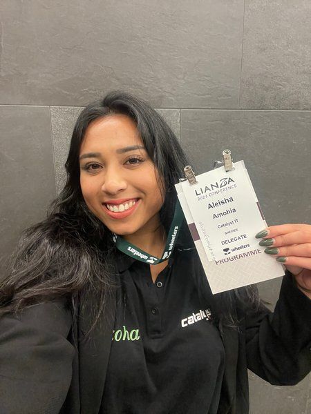 Aleisha Amohia, Koha Technical Lead at Catalyst IT smiles as she wears her LIANZA nametag