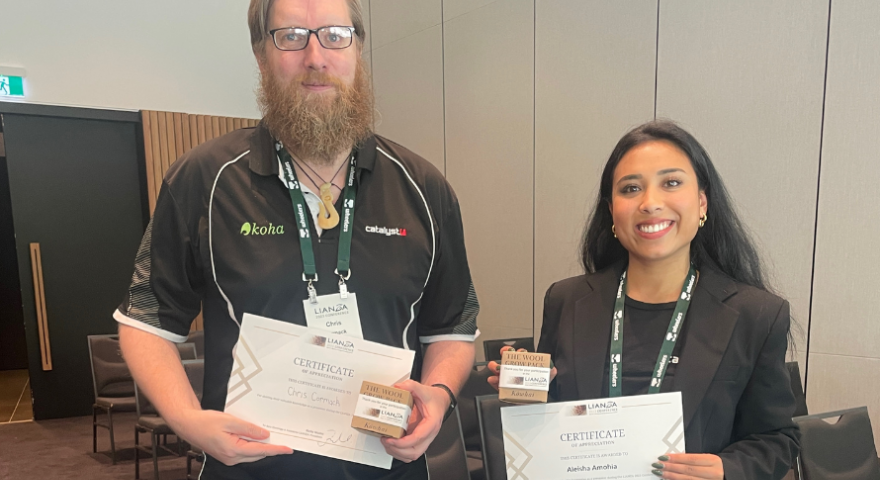 Chris Cormack and Aleisha Amohia holding their speaker certificates and gifts after presenting