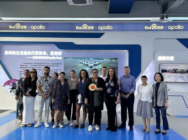 A group of people standing outside the Baidu Apollo park in China.