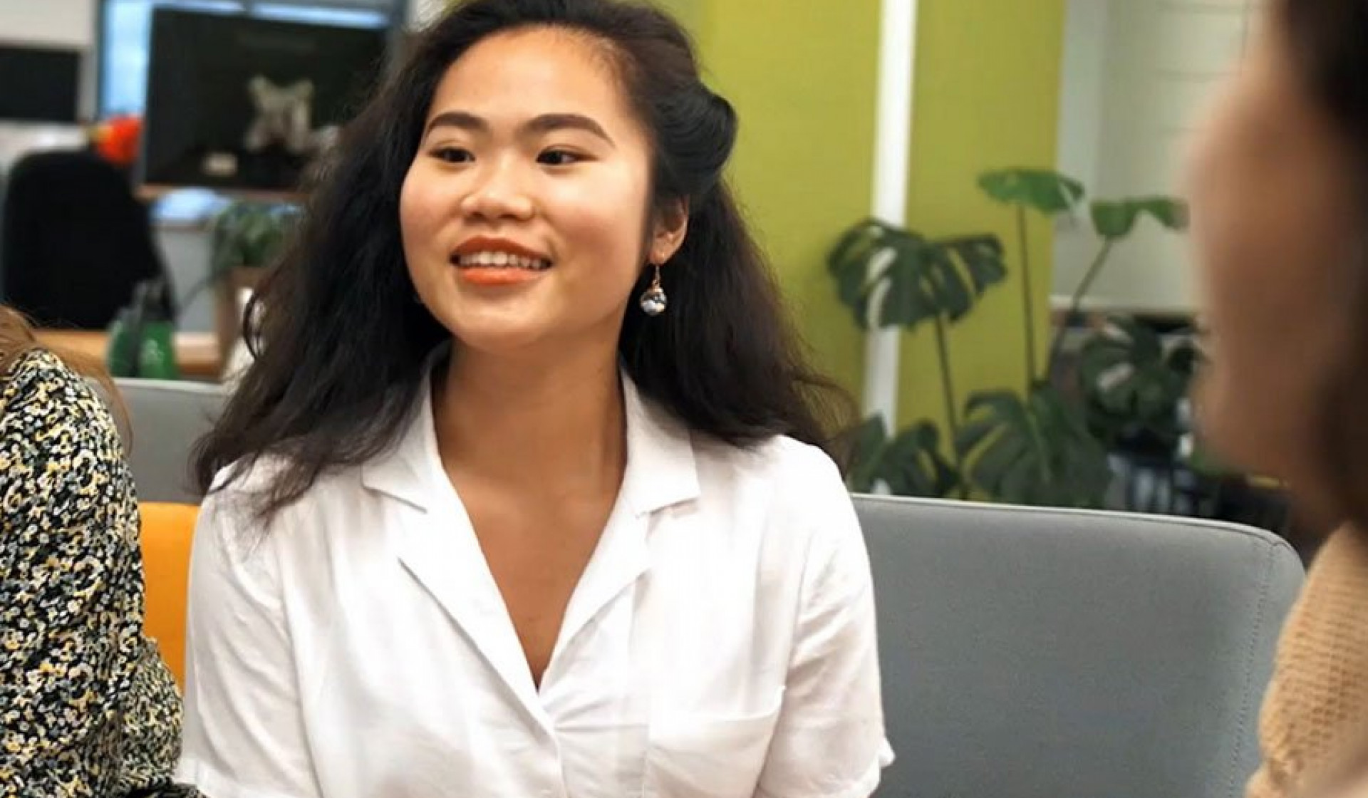 Anh Duong wearing a white shirt and smiling at the camera