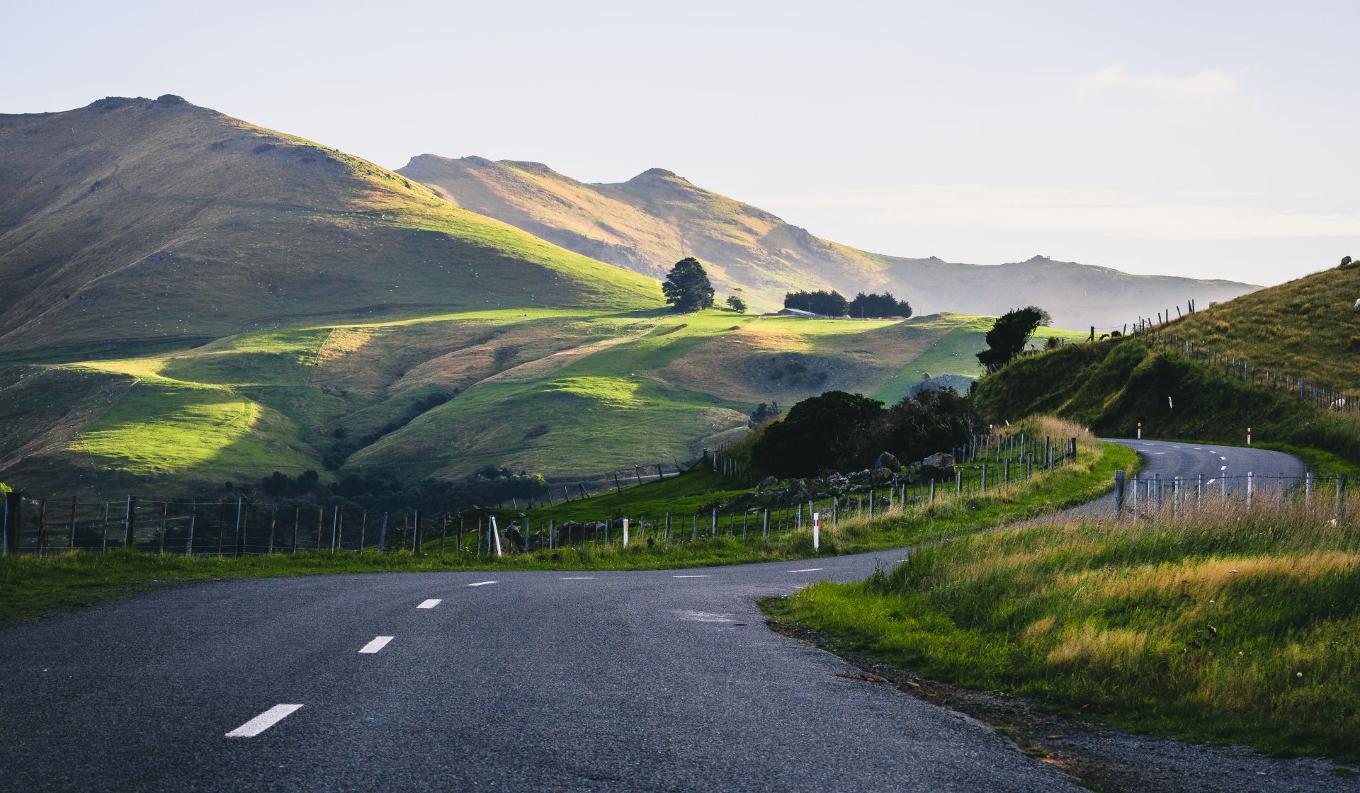 Picture of road winding around a hillside in New Zealand